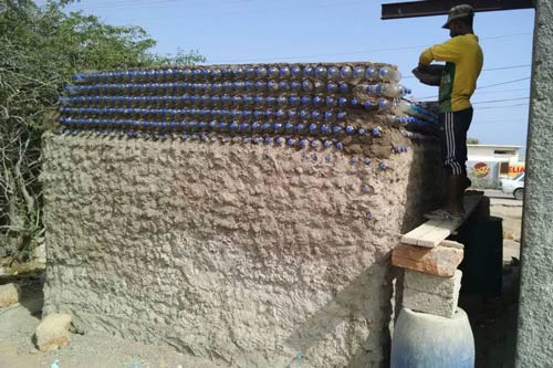 Hut made from plastic bottles and ghost net under contruction