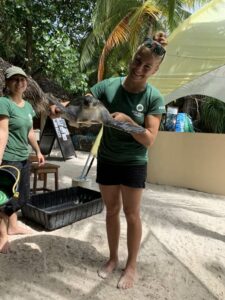 Rolex Scholar Kim with turtle patient Elba who is ready to practice diving skills in the big tank at the ORP Turtle Rescue Centre