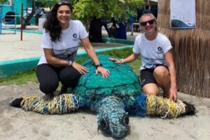 Dr. Claire Petros and Laura Whiteley from ORP with the ghost gear turtle mascot