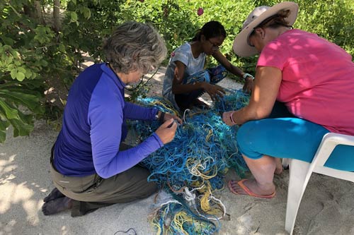 Expedition volunteers sorting recovered ghost nets, Maldives