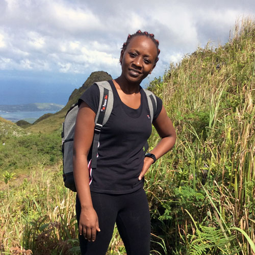 Leah Mainye, a marine biologist in Kenya, on a hike in the mountain. Image.