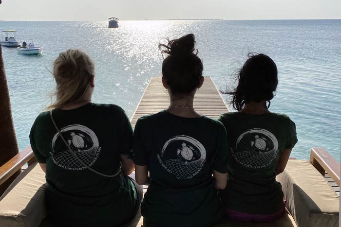 Karam enjoying the sea view with two volunteers, image