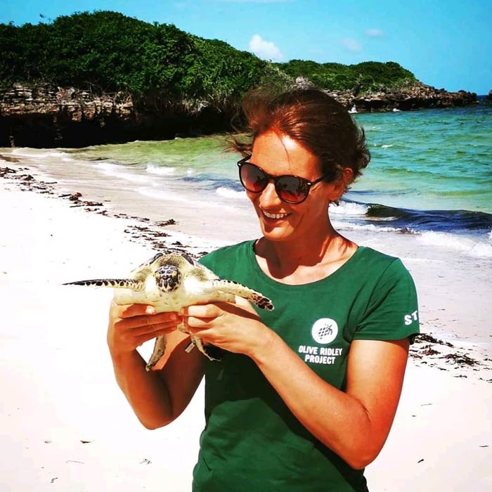 Women in science: Dr. Joana Hanckock with a juvenile green turtle at Diani Beach in Kenya