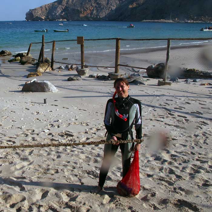 Women in science: Jane Lloyd on the beach after a dive to collect marine debris near Zighy Bay in Oman.