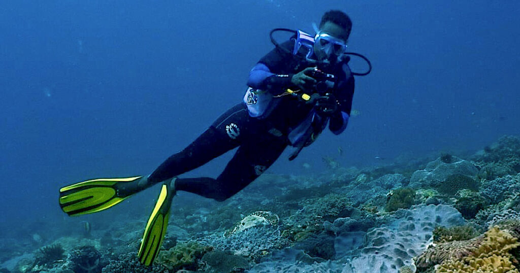 Leha Mainye, marine biologist, conducting turtle photo-id in Kenya. Underwater image.