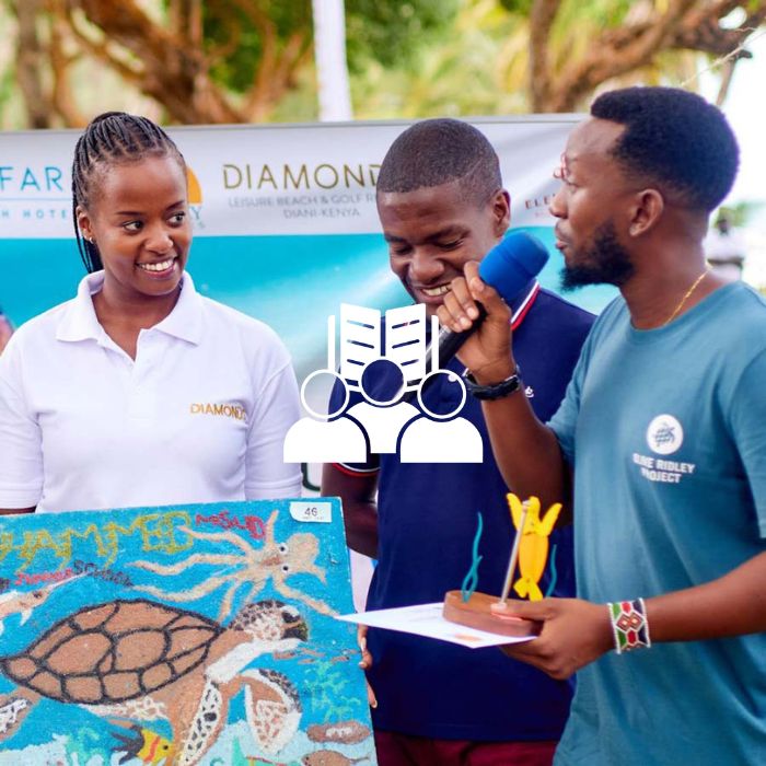An image of Olive Ridley Project conducting educational outreach in Kenya with two participants holding a painting of a sea turtle.